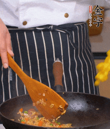 加咖喱塊、少許鹽、白糖調(diào)味，炒至咖喱塊融化后，倒米飯，翻炒至每粒米飯都包裹上咖喱，再放黃椒、青椒粒，出鍋前加菠蘿粒和小蔥翻拌均勻。